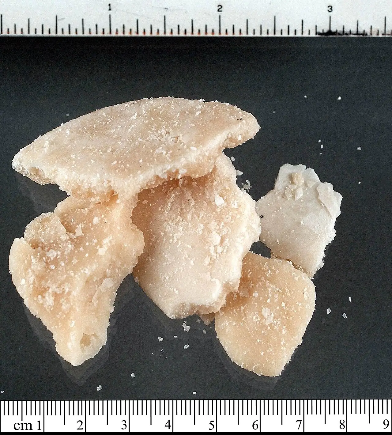 Small pieces of crack cocaine shown beside a ruler for scale