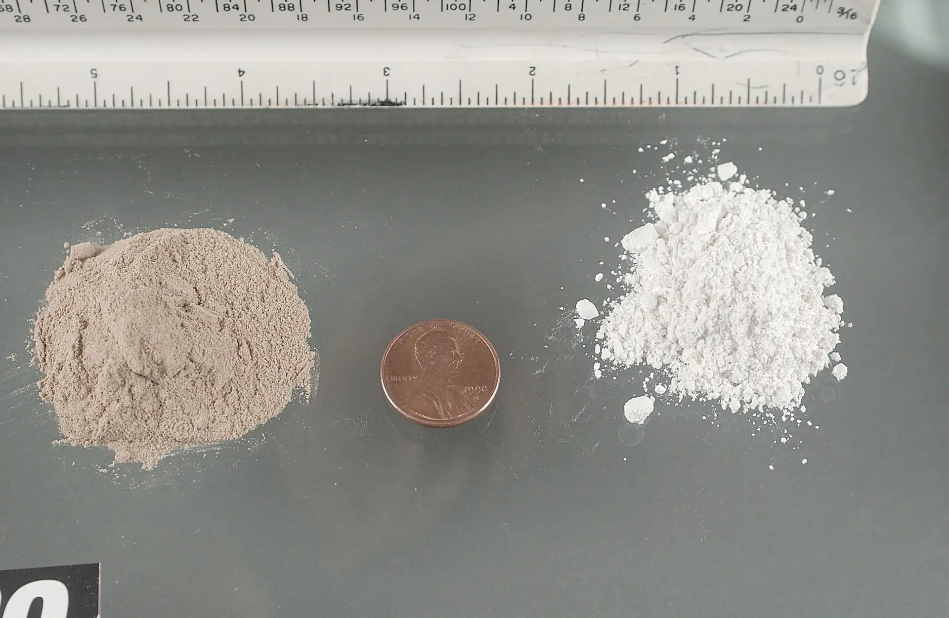 Different forms of heroin shown beside a coin for scale