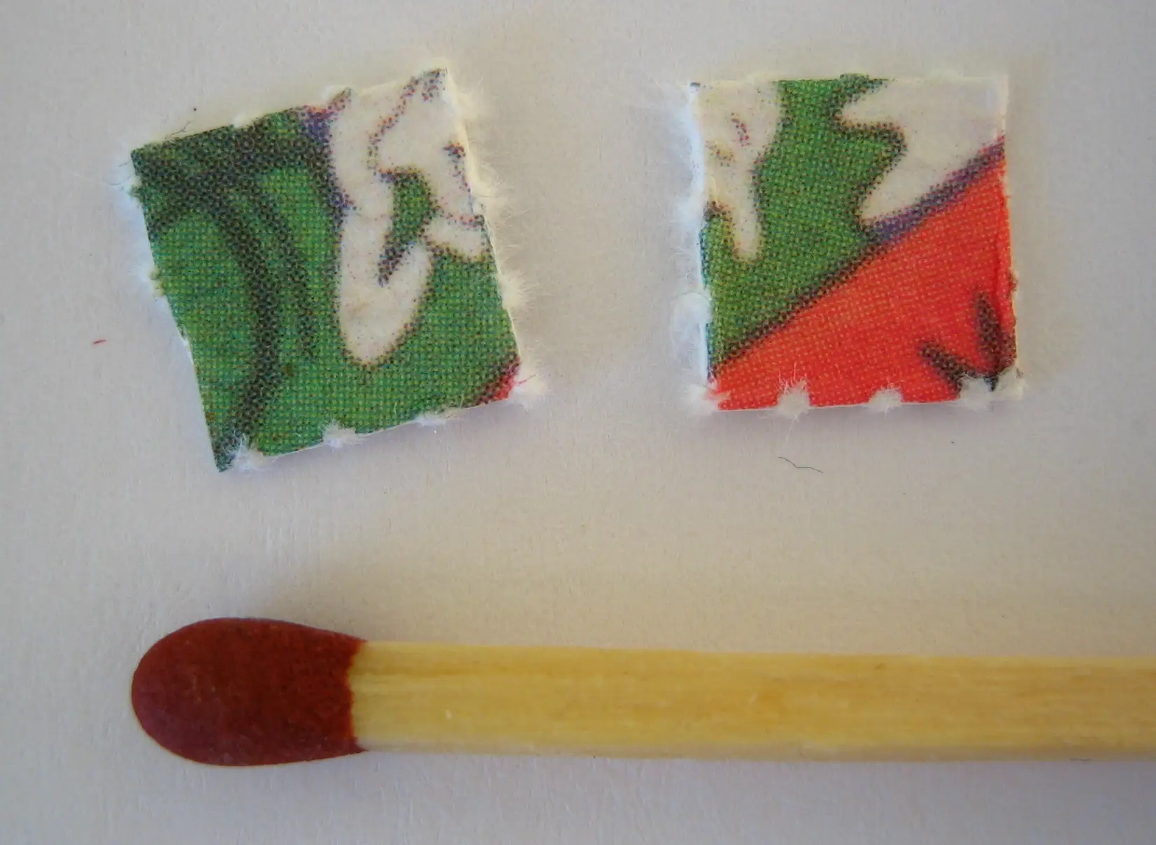 LSD blotter paper shown beside a match for scale
